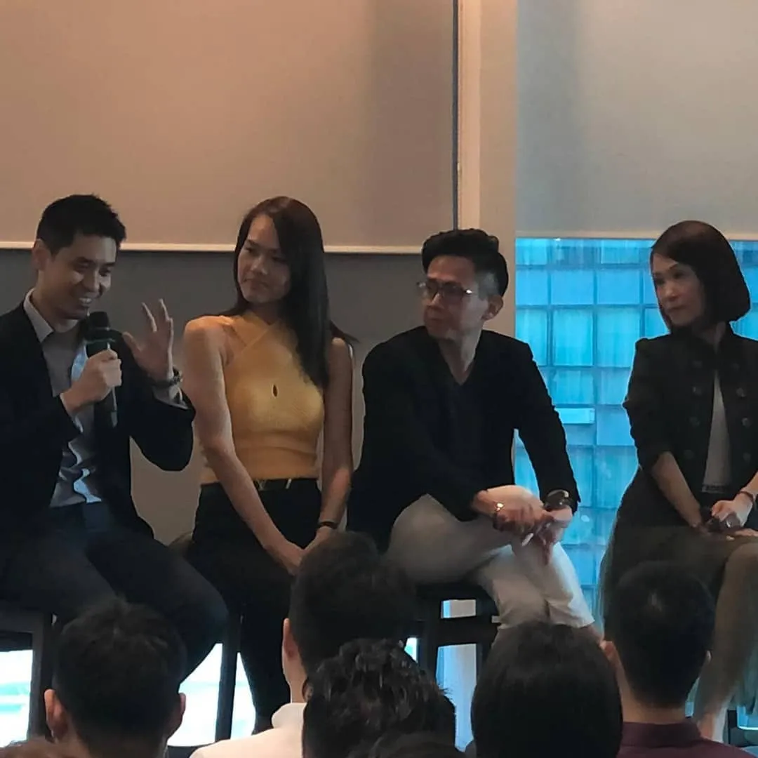 Ling Chun Wei answering a question with a microphone on a finexis adviser panel in 2019
